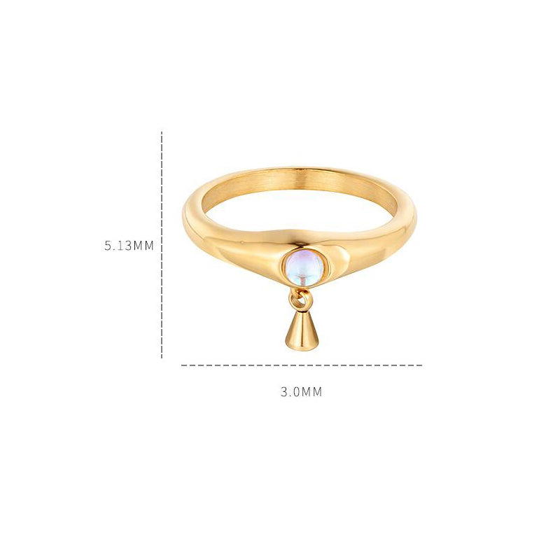 Gold ring with a small gemstone and teardrop-shaped pendant on a white background