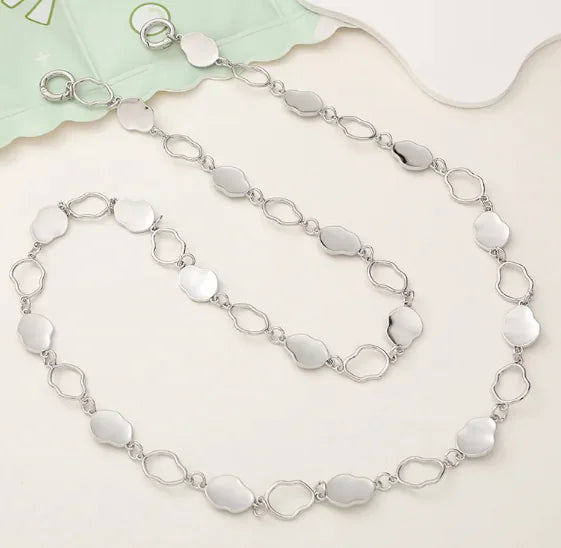 Silver chain necklace on a light background
