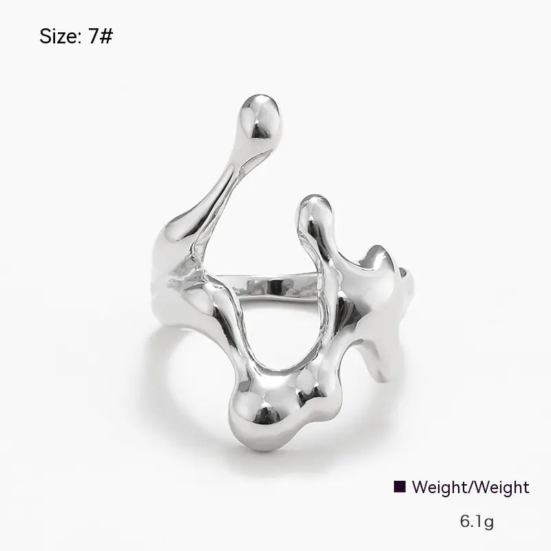 Silver ring with a unique design on a white background