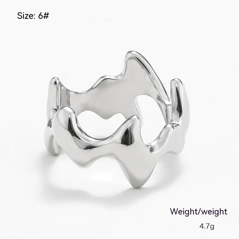 Silver ring with wavy design on a white background