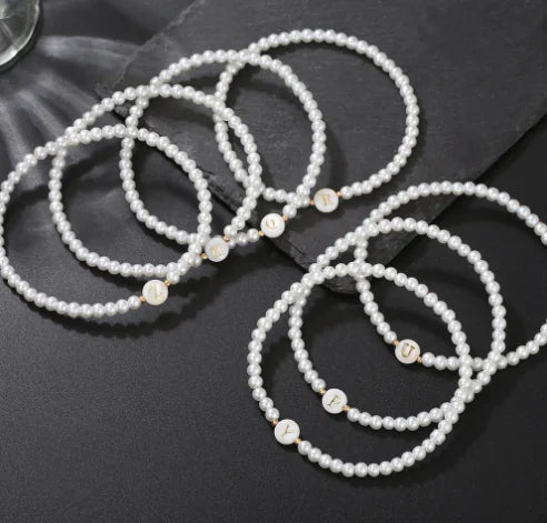 Pearl bracelets on a dark surface