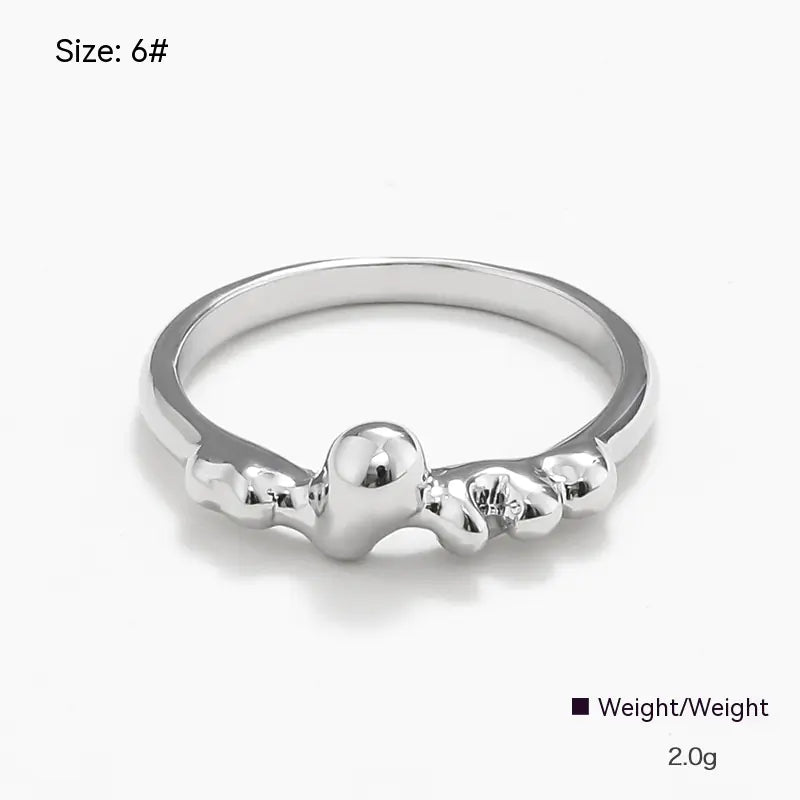 Silver ring with a bow design on a white background