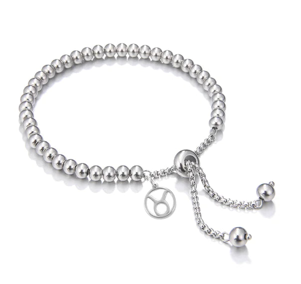Silver beaded bracelet with a chain and charm on a white background