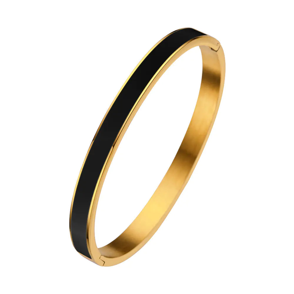 Gold and black bangle on a white background