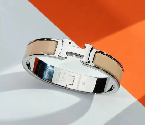 Bracelet with a silver clasp on a white and orange background