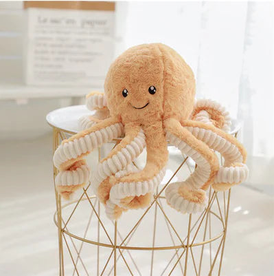 Plush octopus toy on a small stool with a blurred background