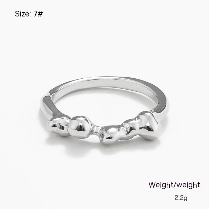 Silver ring with a unique design on a white background
