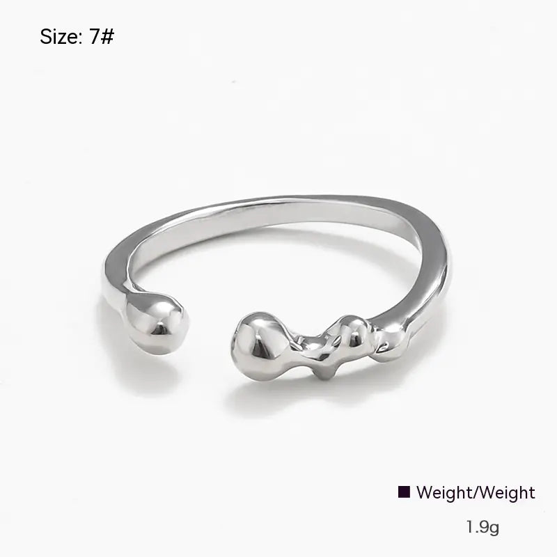Silver ring with a unique design on a white background