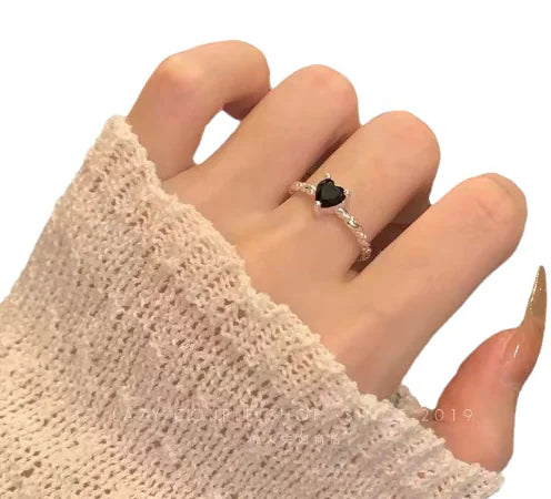 Sterling-silver twist ring with black zirconia centre stone resting on finger