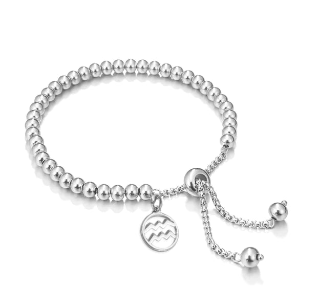 Silver beaded bracelet with a charm on a white background