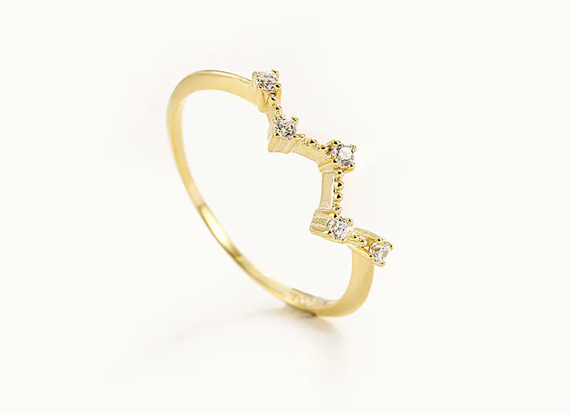 Gold ring with small diamonds on a white background