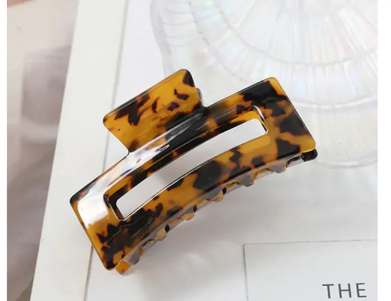 Tortoiseshell patterned hair clip on a white background