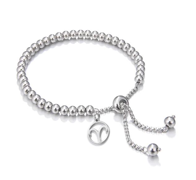 Silver beaded bracelet with a charm on a white background