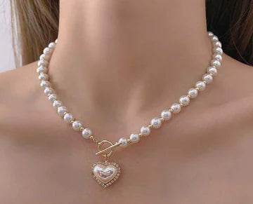 Pearl necklace with a heart-shaped pendant on a mannequin