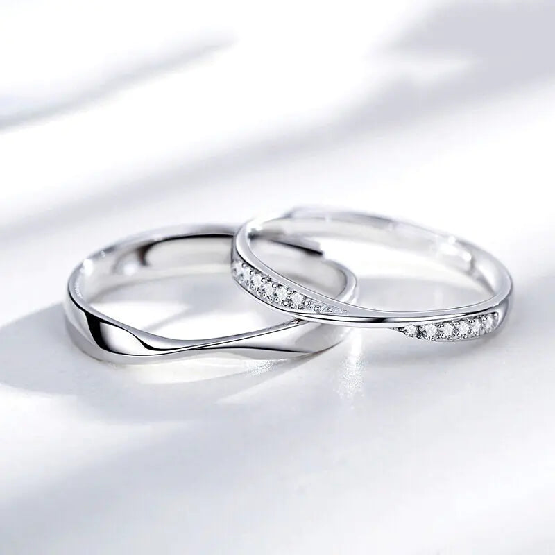 Two silver rings with diamond accents on a white background