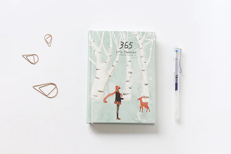 Life planner with nature-themed cover featuring a person and a deer, on a white background.