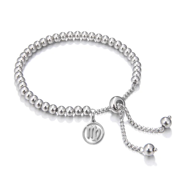 Silver beaded bracelet with a circular charm on a white background