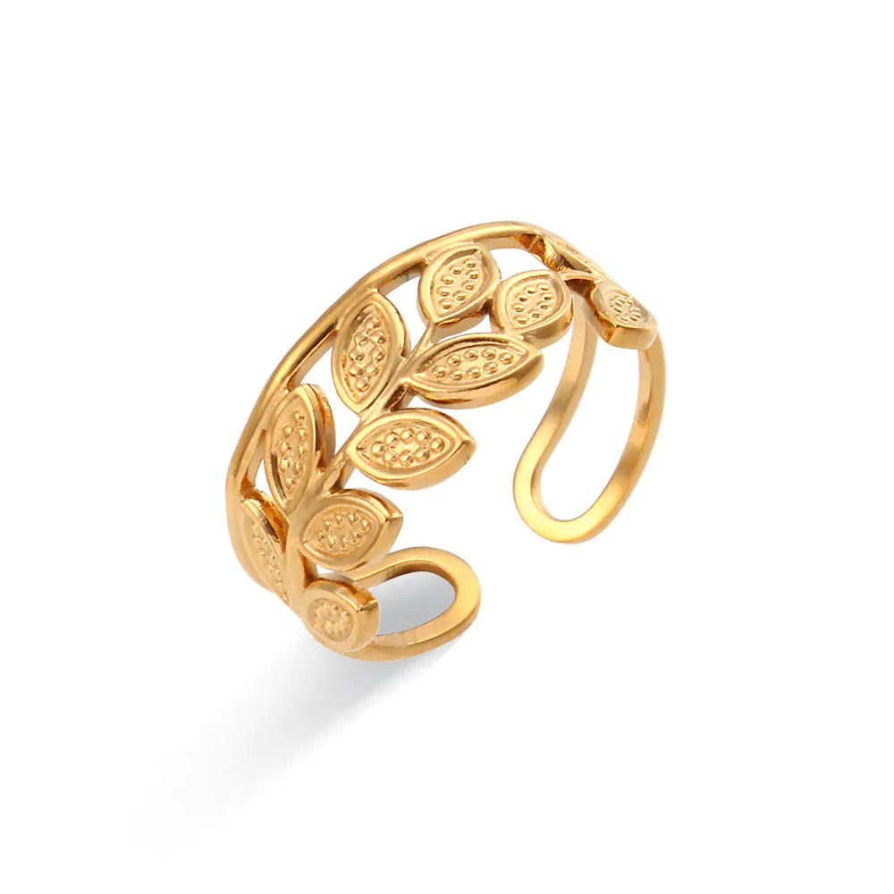 Gold leaf-patterned ring on a white background