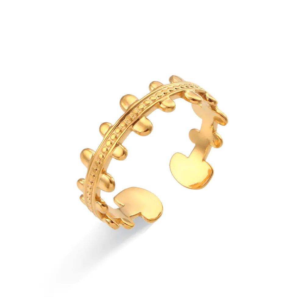 Gold ring with heart design on a white background
