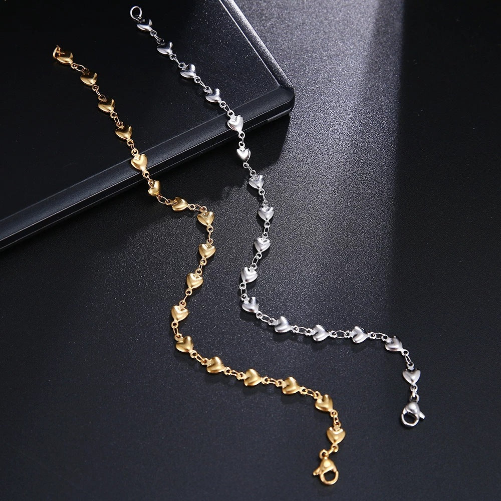Gold and silver chain necklace on a dark surface