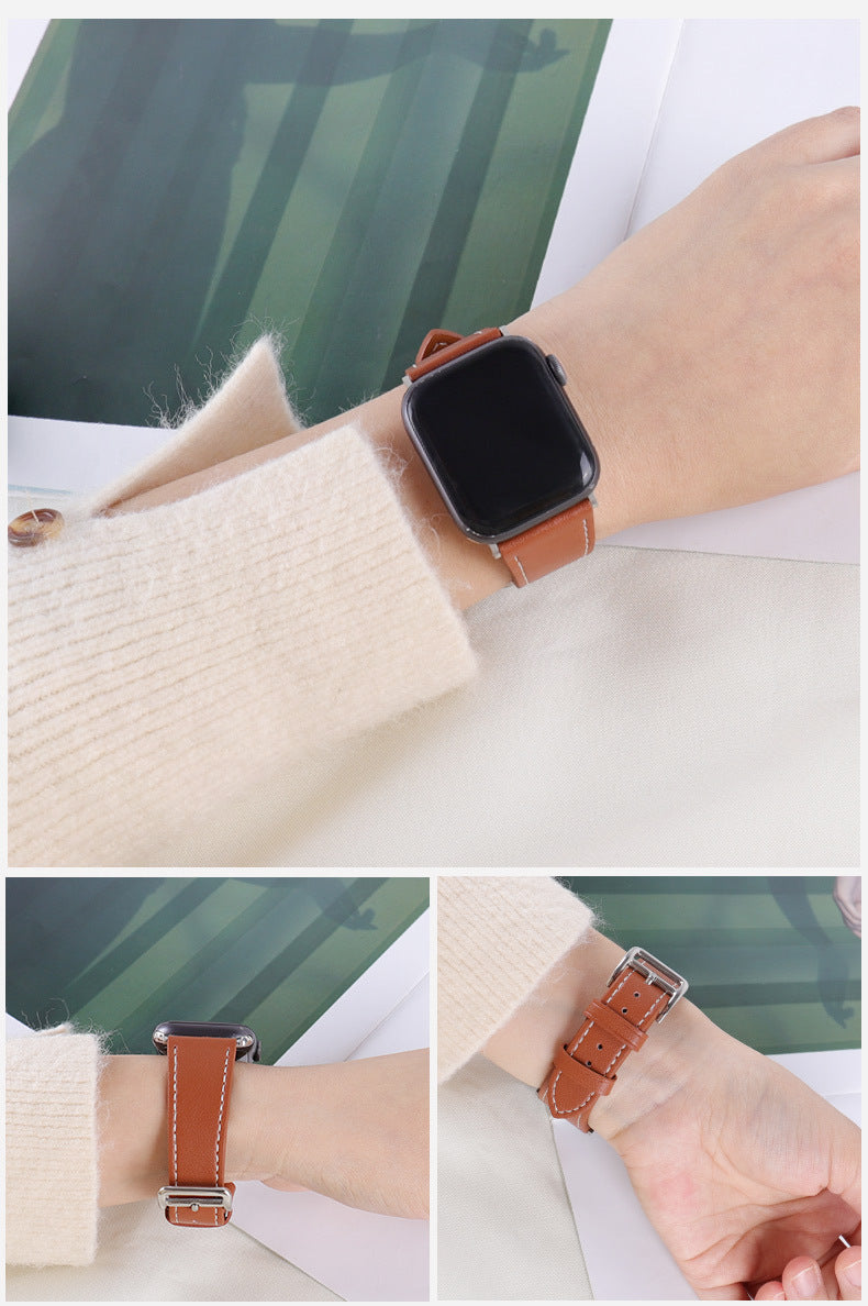 Smartwatch with a brown leather strap worn on a wrist, with a blurred green and white background.