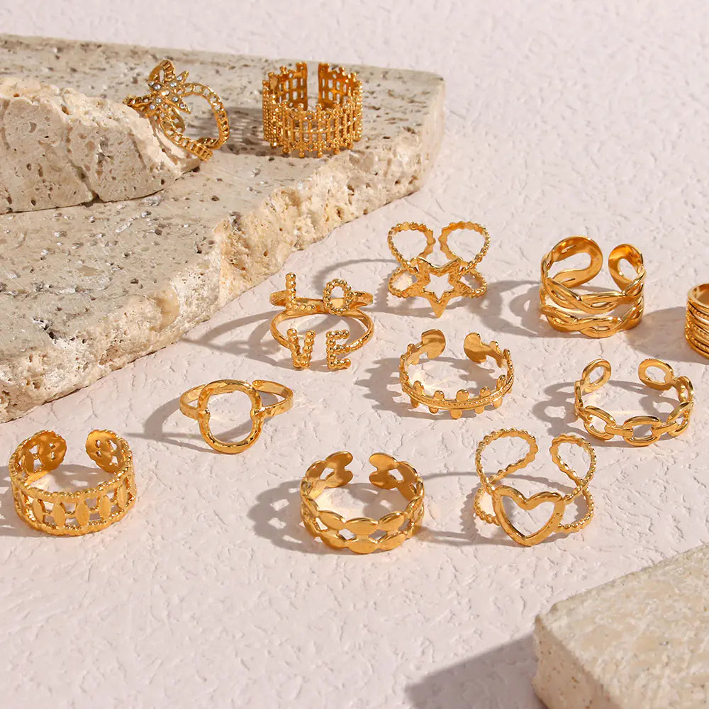 Collection of gold rings on a textured surface