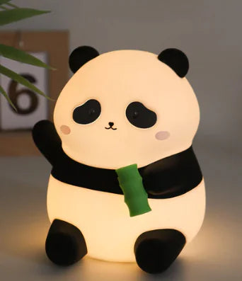 Cute panda-shaped night light with a green leaf on a neutral background