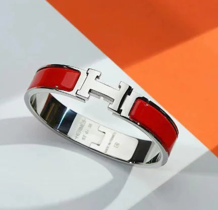 Bracelet with red and silver design on a white and orange background
