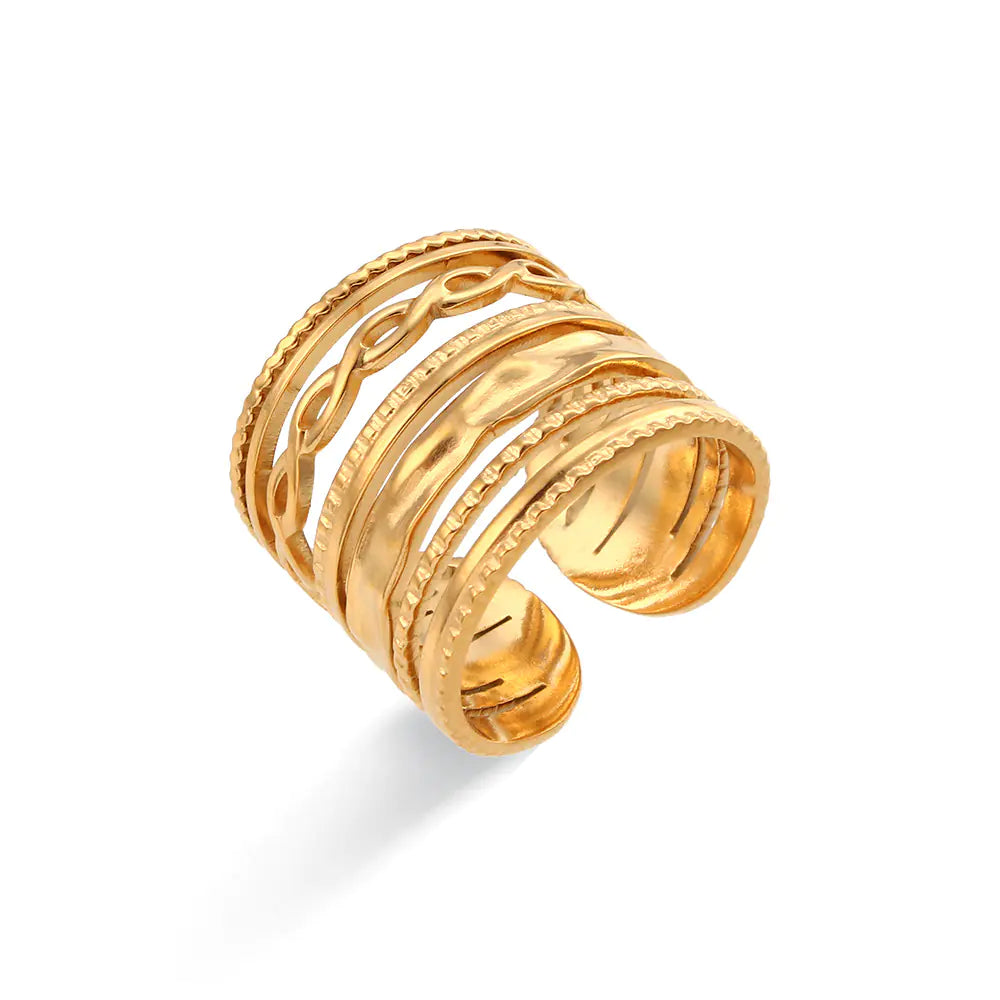 Gold ring with intricate designs on a white background