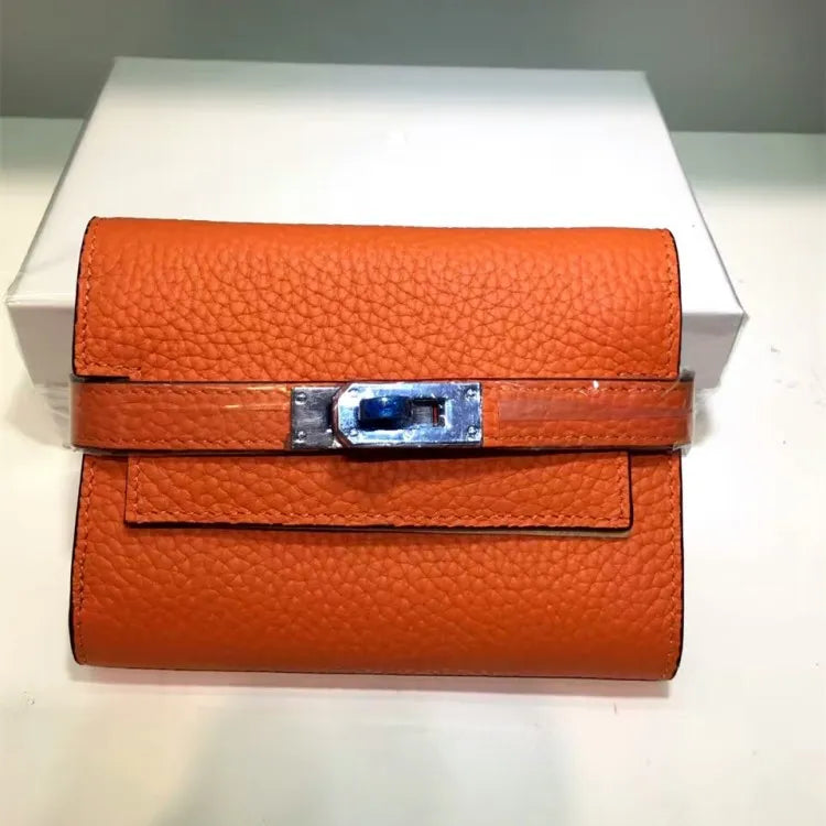 Orange leather wallet with a silver clasp on a white background