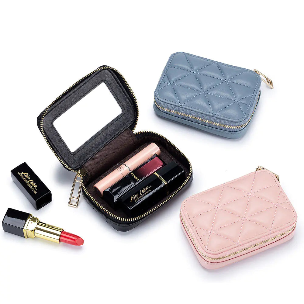 Makeup set with lipsticks and a compact mirror on a white background