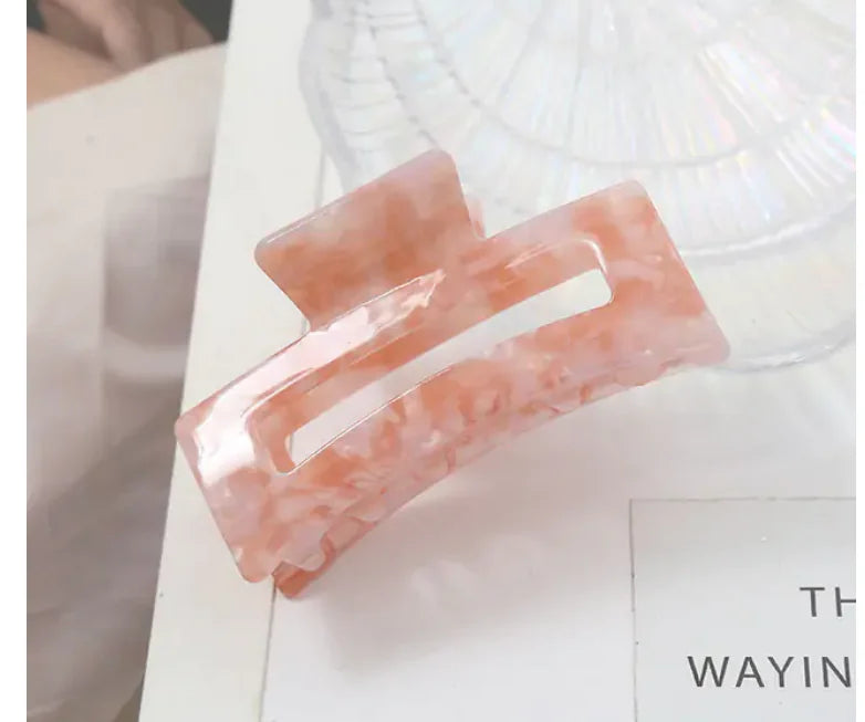 Pink hair clip on a white surface