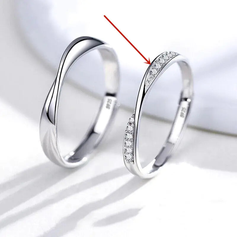 Two silver rings on a white background with one ring having a red arrow pointing to it.