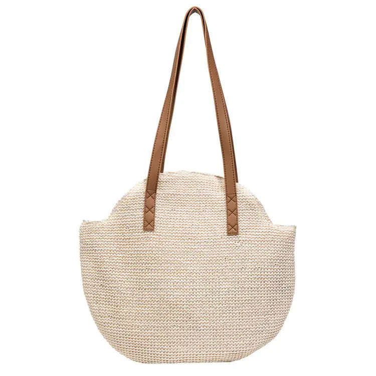 Beige woven handbag with brown leather straps on a white background