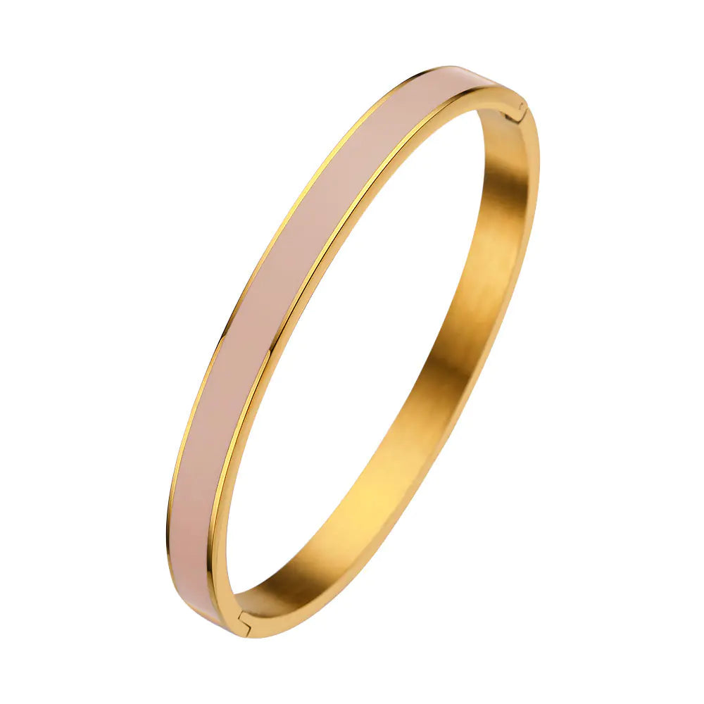 Gold and pink bangle on a white background