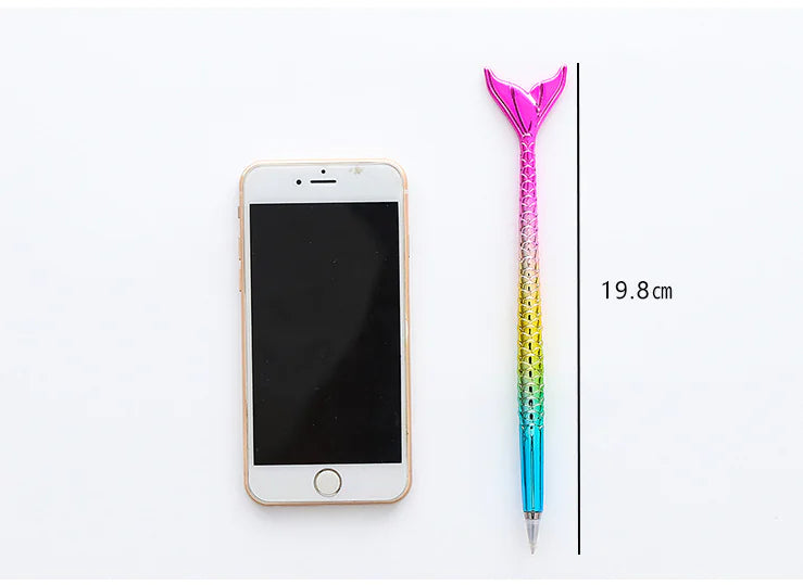 Colorful pen with mermaid tail design next to a smartphone on a white background