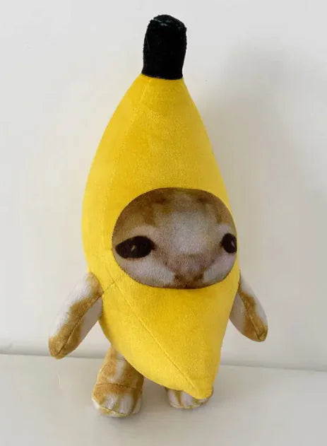 Stuffed toy shaped like a banana with a face on a white background