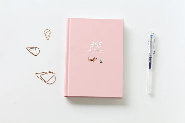 Pink planner with decorative elements on a white background