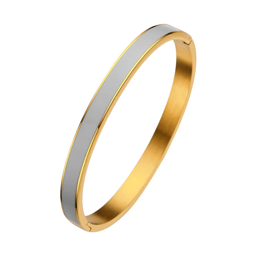 Gold and silver bangle on a white background