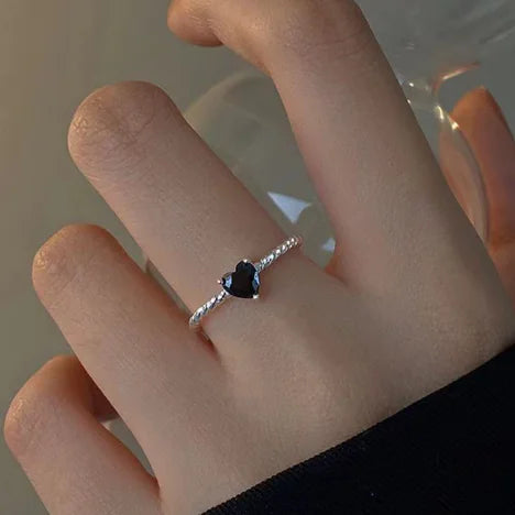 Sterling-silver twist ring with black zirconia centre stone resting on finger
