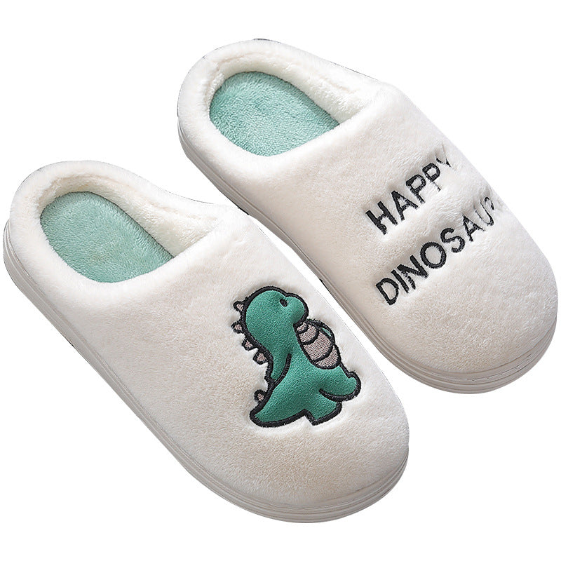 White slippers with dinosaur design and 'Happy Dinosaur' text on a white background