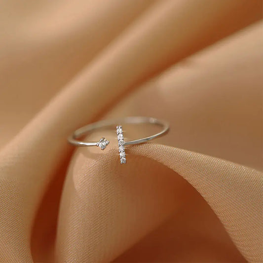 Silver ring with small diamonds on a beige fabric background