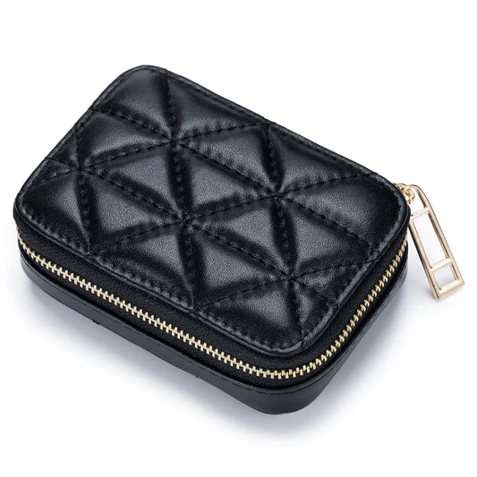 Black quilted jewelry case with gold zipper on a white background