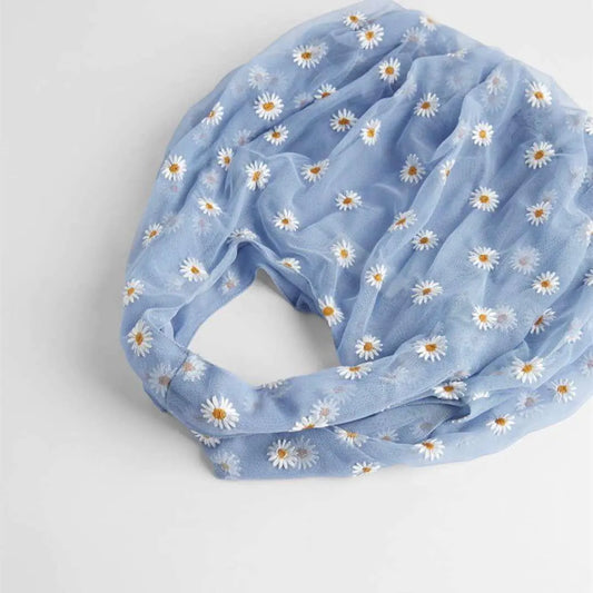 Light blue tote bag with white daisy pattern on a white background