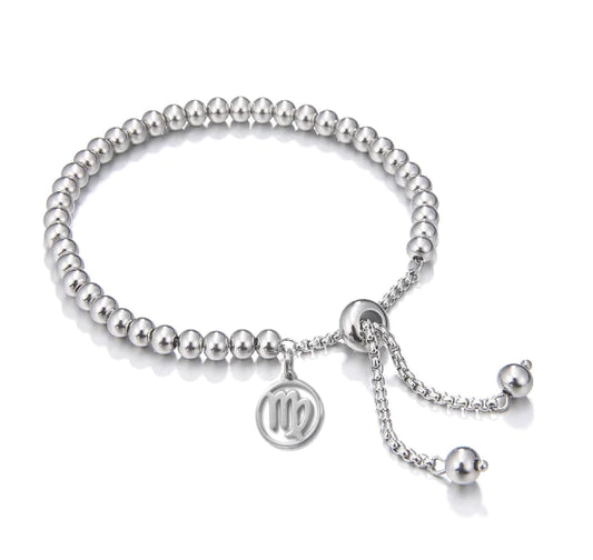Silver beaded bracelet with a circular charm on a white background