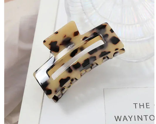 Leopard print hair clip on a white surface