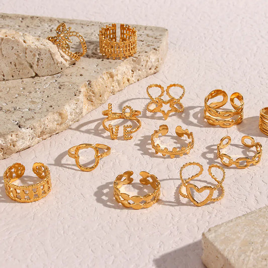Collection of gold rings on a textured surface