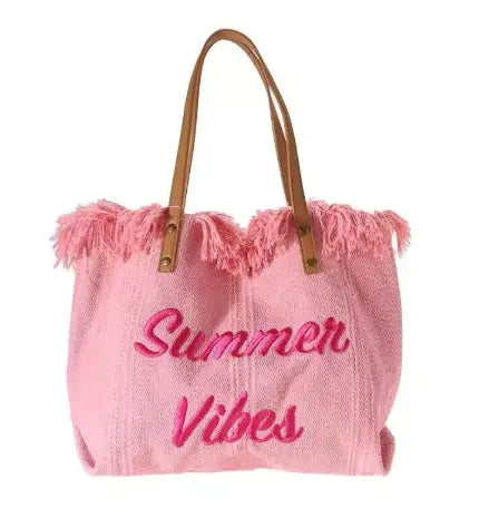 Pink tote bag with 'Summer Vibes' text and frayed edges on a white background