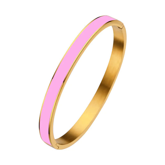 Gold bangle with a pink interior on a white background