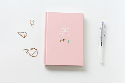 Pink planner with decorative elements on a white background